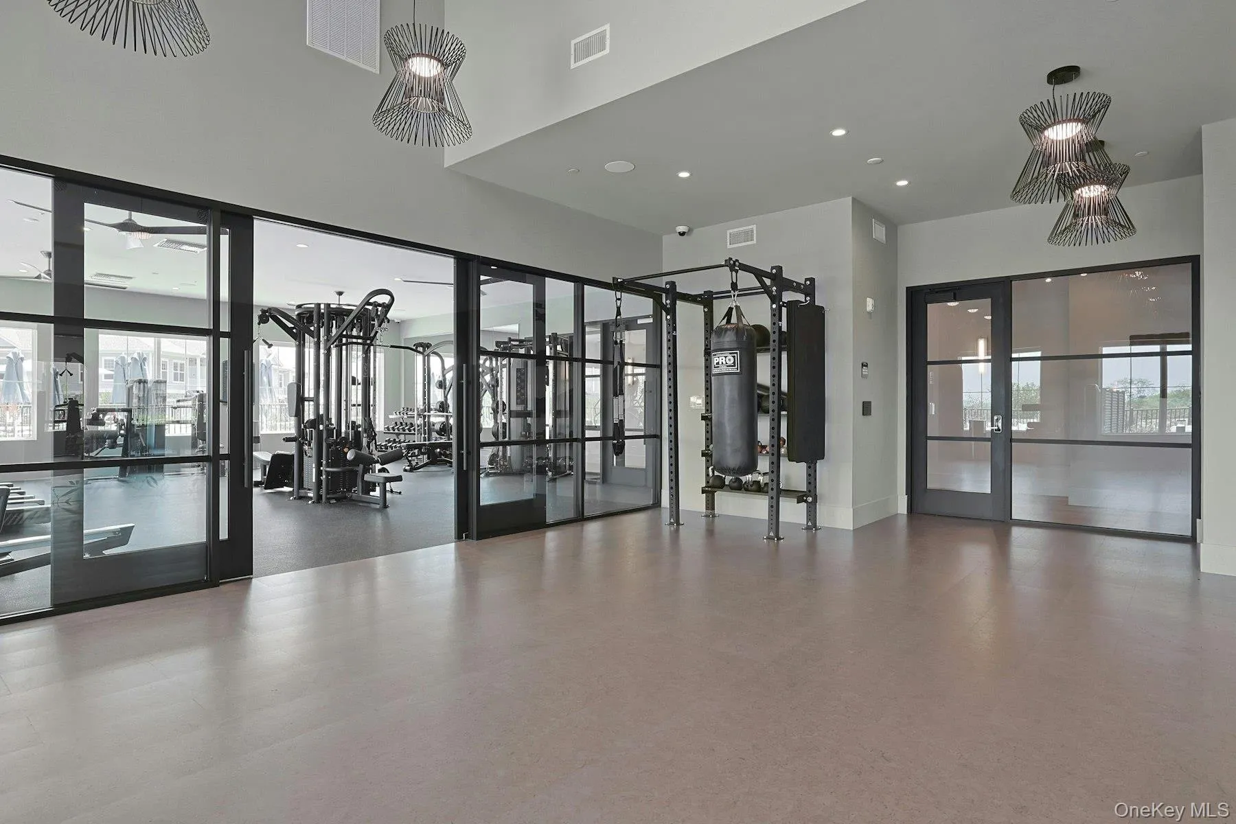 Workout area with a towering ceiling, plenty of natural light, and a ceiling fan Workout area with a towering ceiling, plenty of natural light, and a ceiling fan