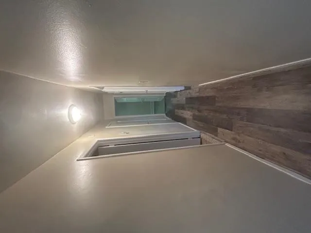 Hall with wood finished floors and baseboards Hall with wood finished floors and baseboards