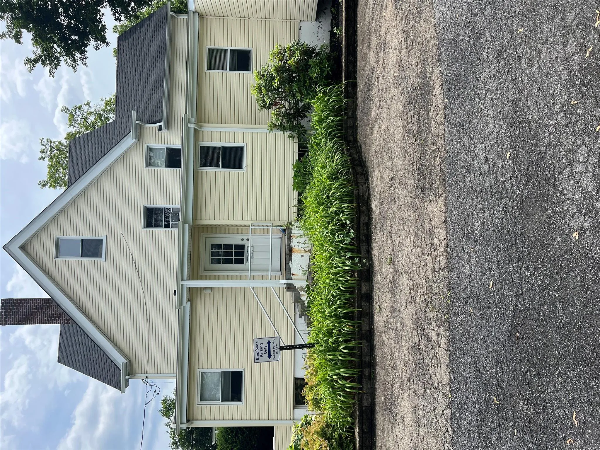 Back of property featuring a chimney and roof with shingles Back of property featuring a chimney and roof with shingles