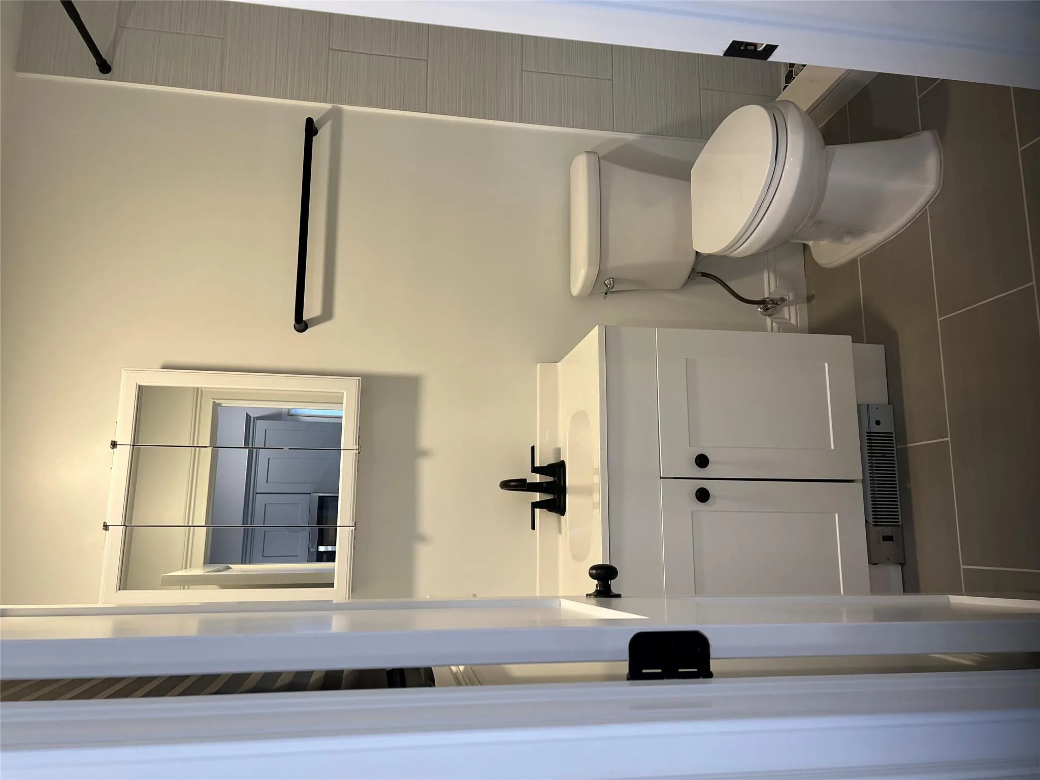 Bathroom featuring vanity, tile patterned floors, and tiled shower Bathroom featuring vanity, tile patterned floors, and tiled shower