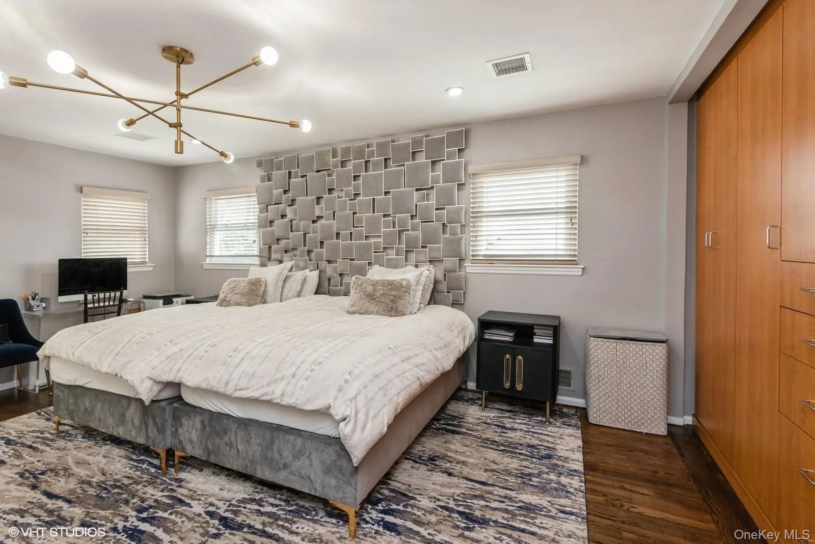 Bedroom with dark wood finished floors, a chandelier, and recessed lighting Bedroom with dark wood finished floors, a chandelier, and recessed lighting