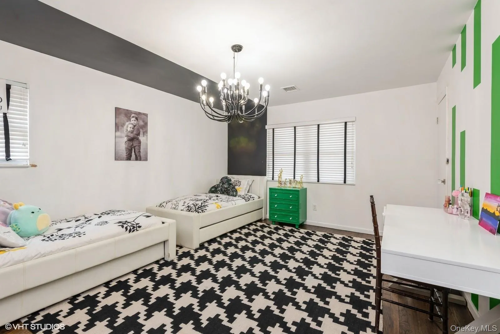 Bedroom featuring wood finished floors and a chandelier Bedroom featuring wood finished floors and a chandelier