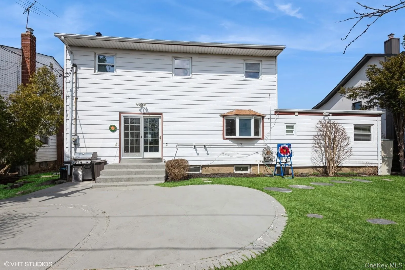 Back of house with a lawn Back of house with a lawn