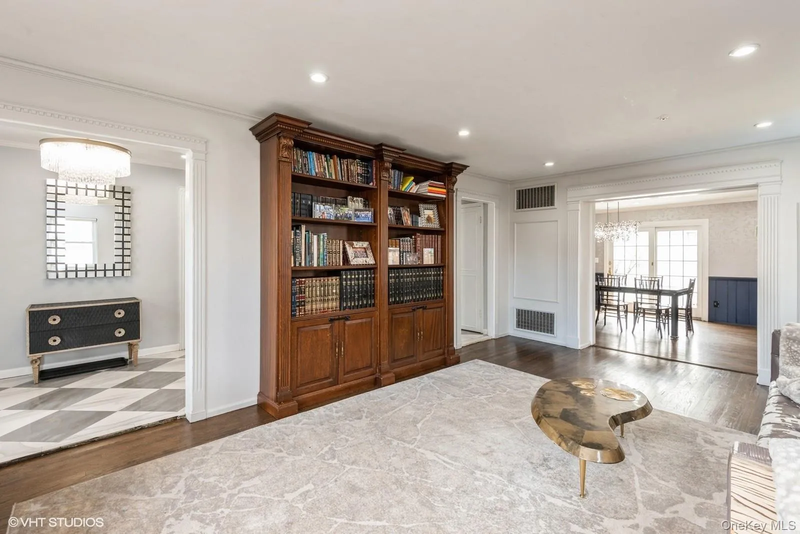 Sitting room with wood finished floors, a chandelier, crown molding, and recessed lighting Sitting room with wood finished floors, a chandelier, crown molding, and recessed lighting