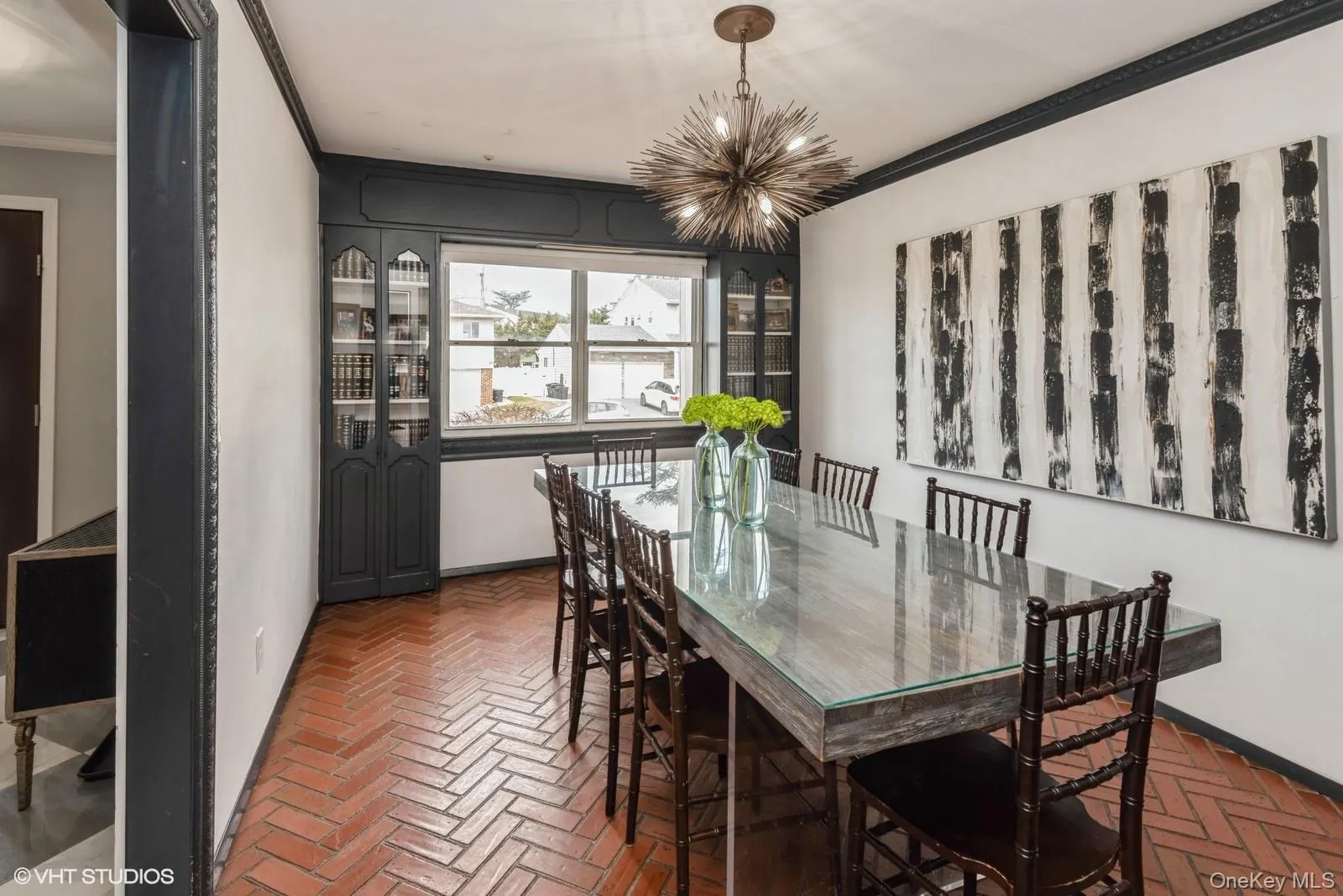 Dining space with brick floors, ornamental molding, and a chandelier Dining space with brick floors, ornamental molding, and a chandelier