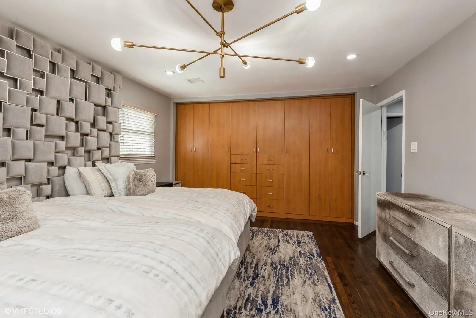 Bedroom featuring dark wood finished floors, recessed lighting, and a chandelier Bedroom featuring dark wood finished floors, recessed lighting, and a chandelier