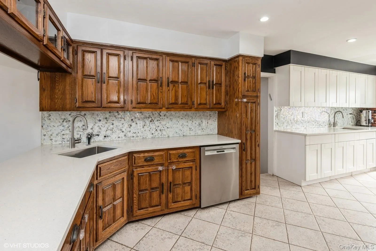 Kitchen with backsplash, dishwasher, light stone countertops, brown cabinets, and recessed lighting Kitchen with backsplash, dishwasher, light stone countertops, brown cabinets, and recessed lighting