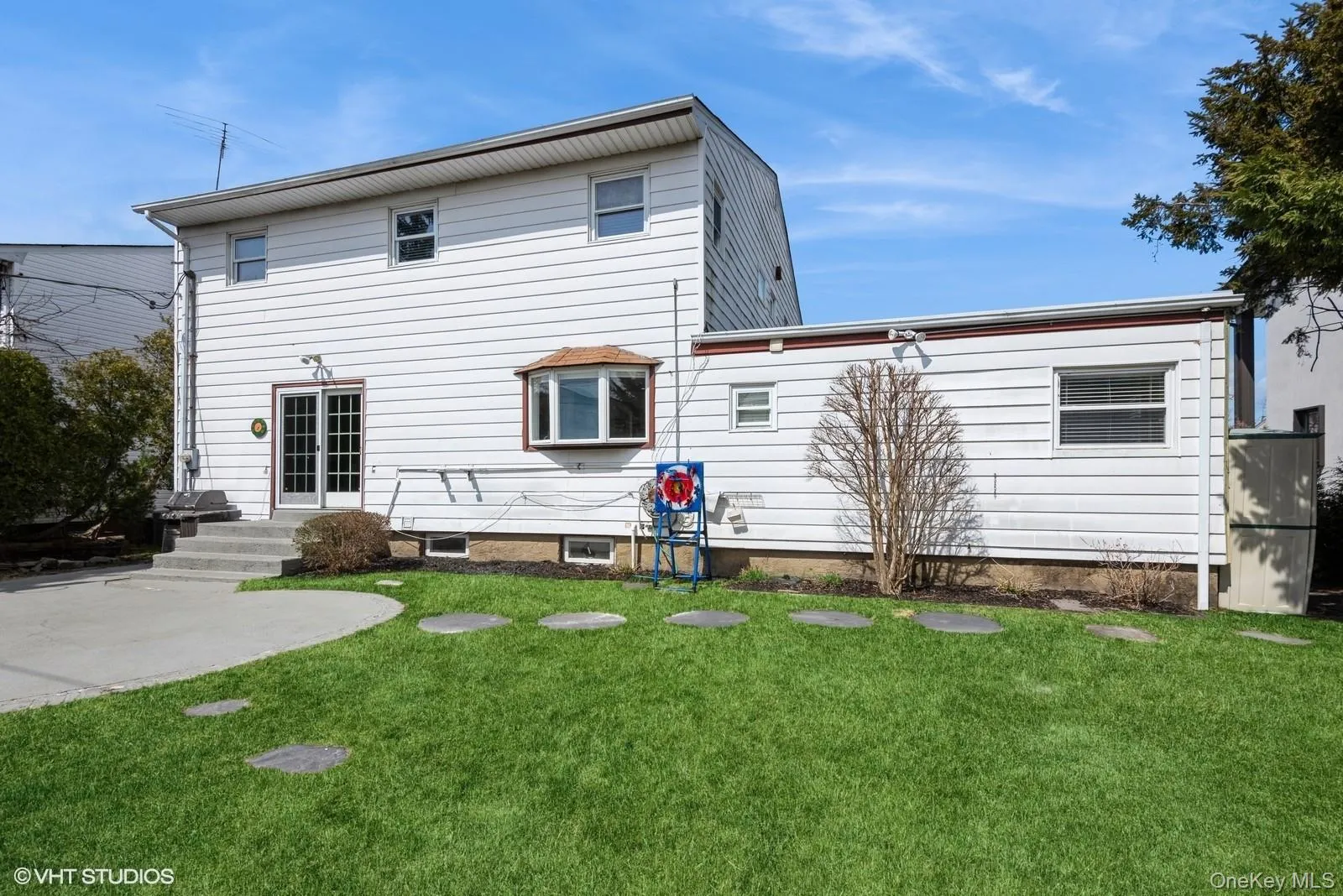 Rear view of house featuring a yard Rear view of house featuring a yard