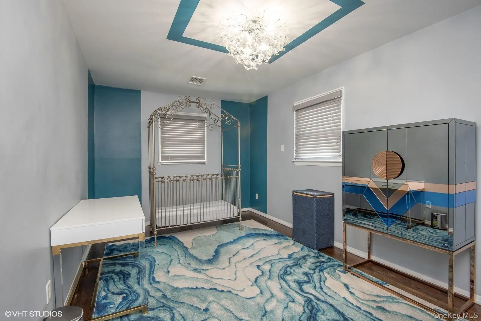Bedroom featuring wood finished floors and a chandelier Bedroom featuring wood finished floors and a chandelier