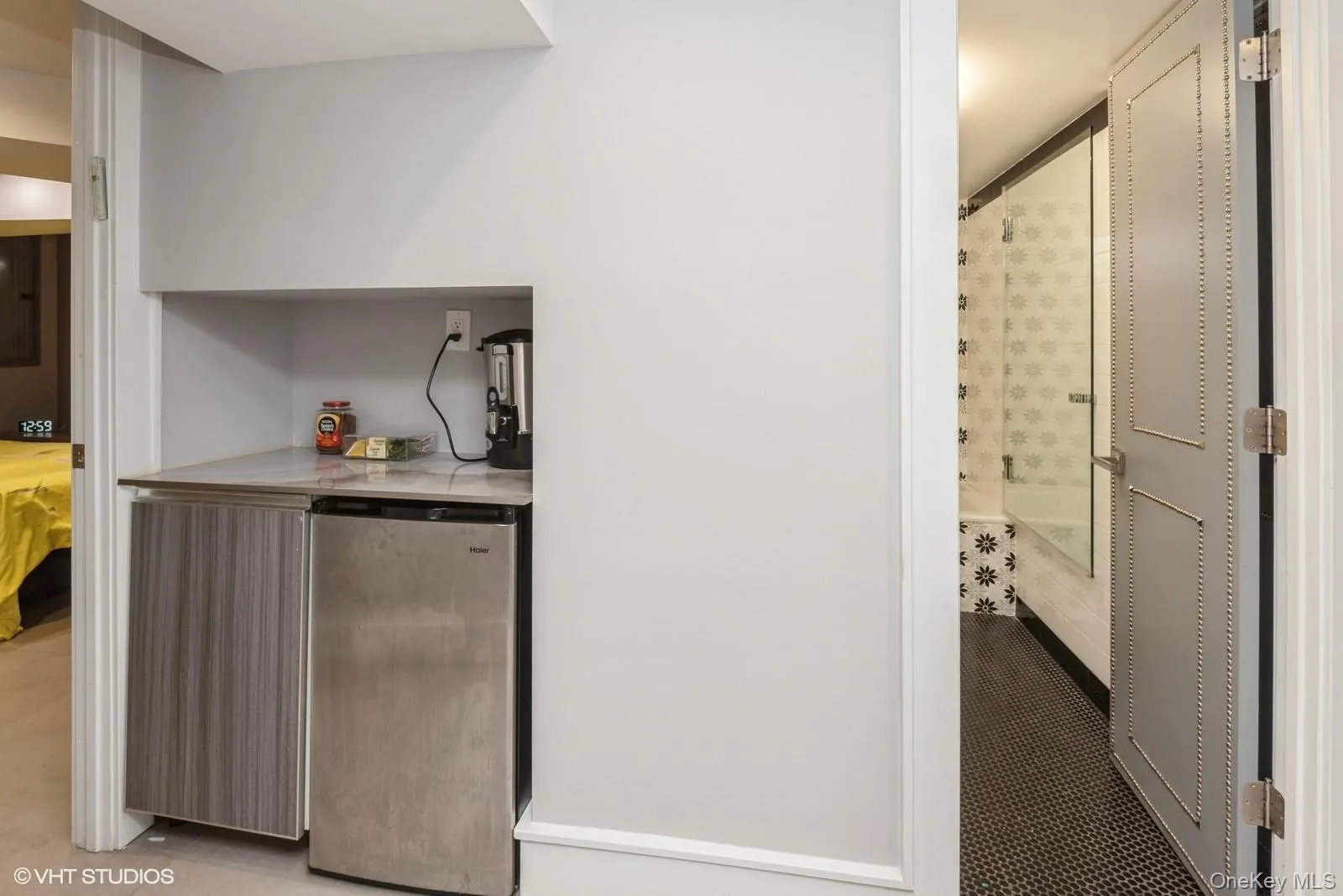 Bar area with stainless steel fridge and light countertops Bar area with stainless steel fridge and light countertops