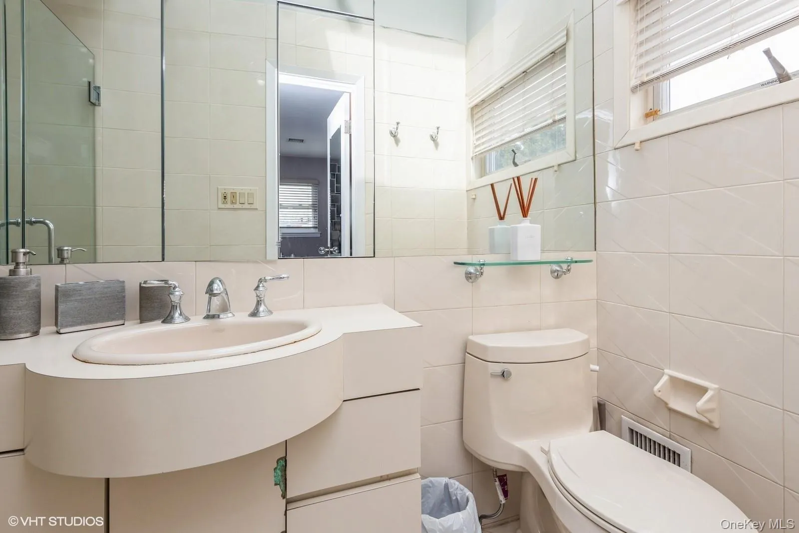 Bathroom with tile walls, decorative backsplash, and vanity Bathroom with tile walls, decorative backsplash, and vanity