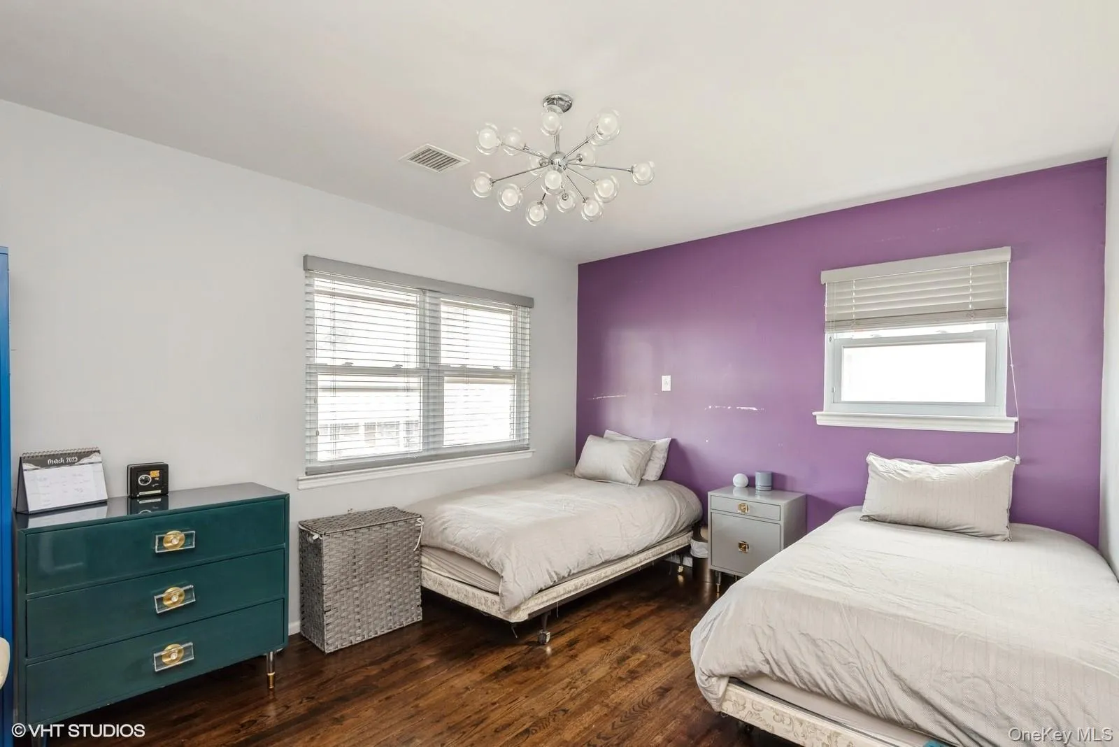 Bedroom featuring dark wood-style floors and a chandelier Bedroom featuring dark wood-style floors and a chandelier