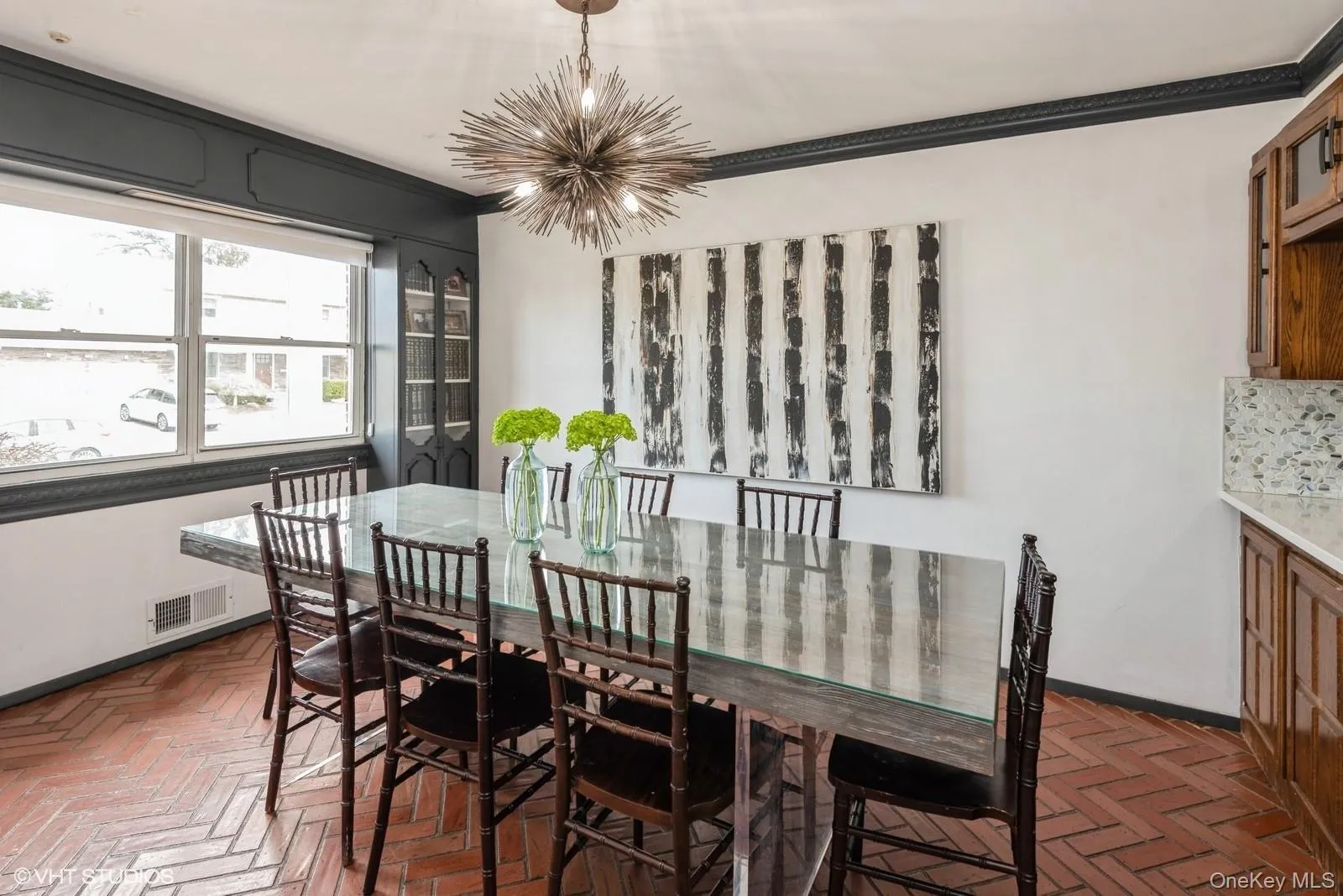 Dining space with ornamental molding and a chandelier Dining space with ornamental molding and a chandelier