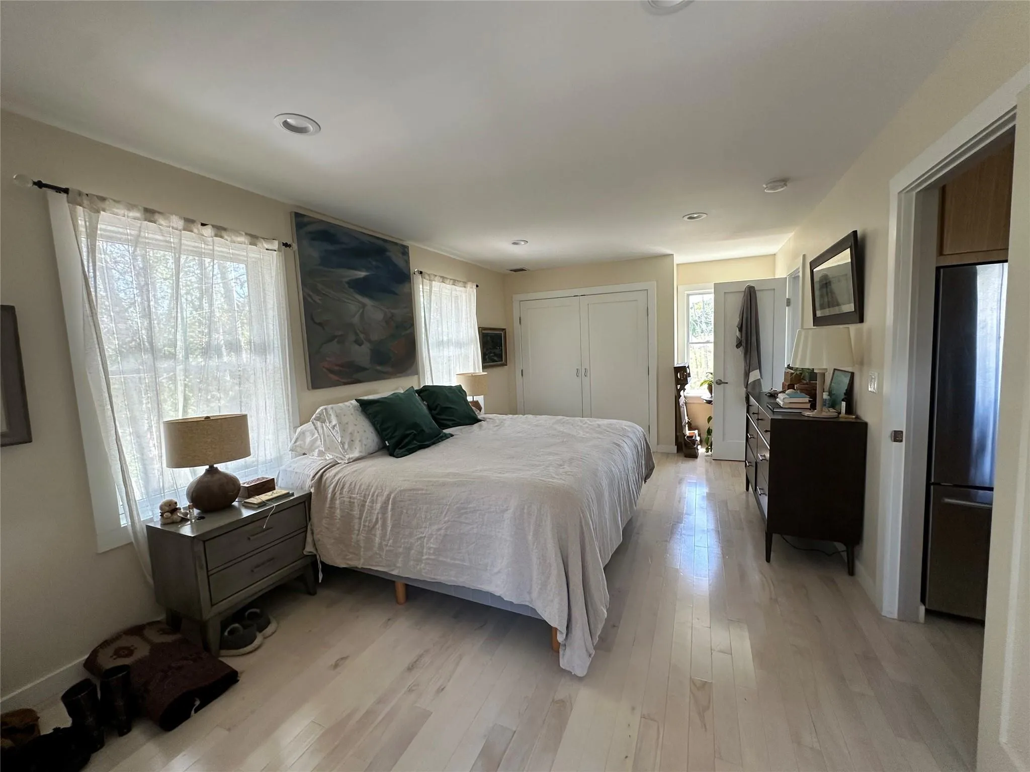 Bedroom featuring freestanding refrigerator, light wood-type flooring, a closet, and recessed lighting Bedroom featuring freestanding refrigerator, light wood-type flooring, a closet, and recessed lighting