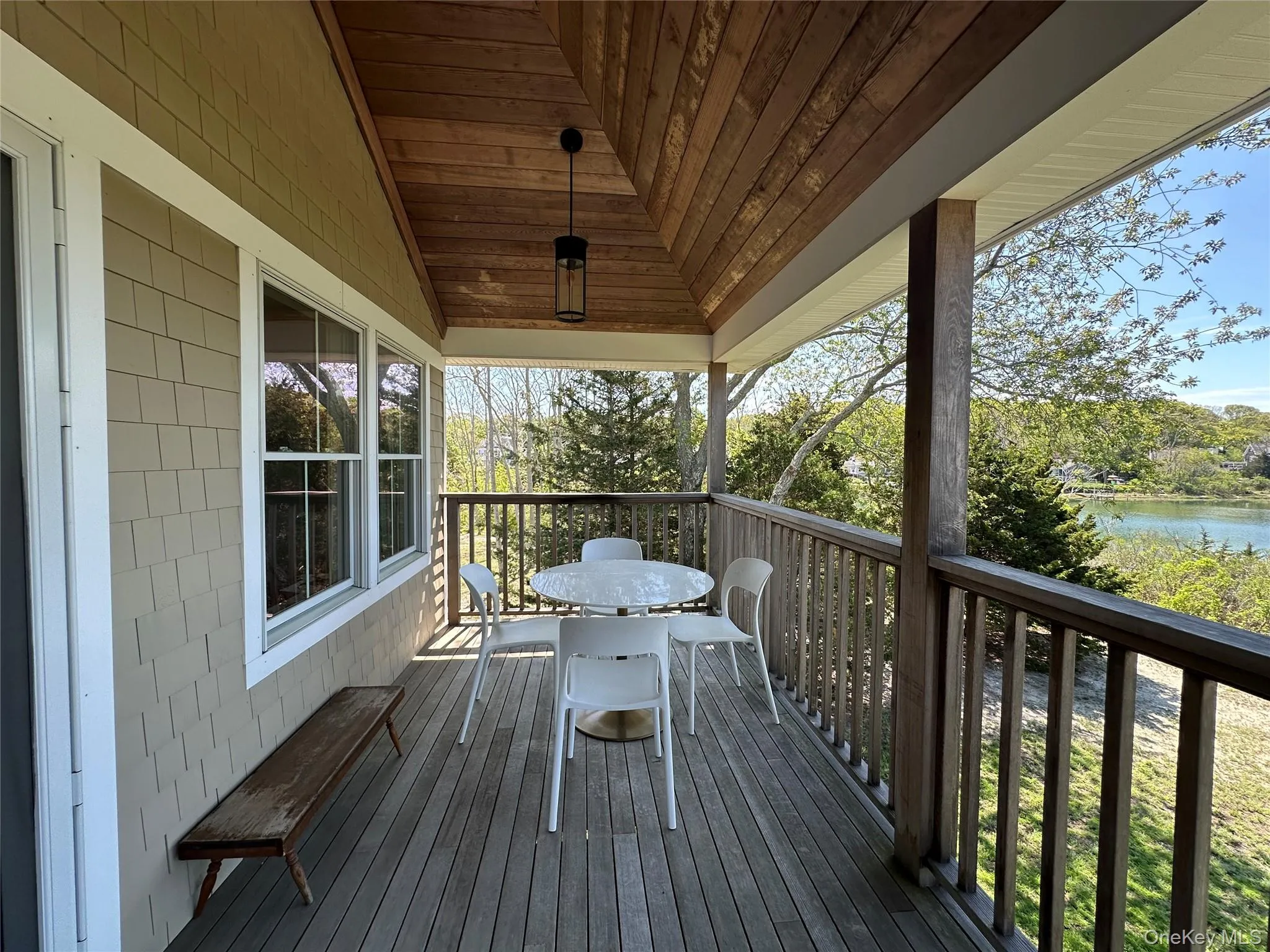Wooden terrace featuring a water view Wooden terrace featuring a water view