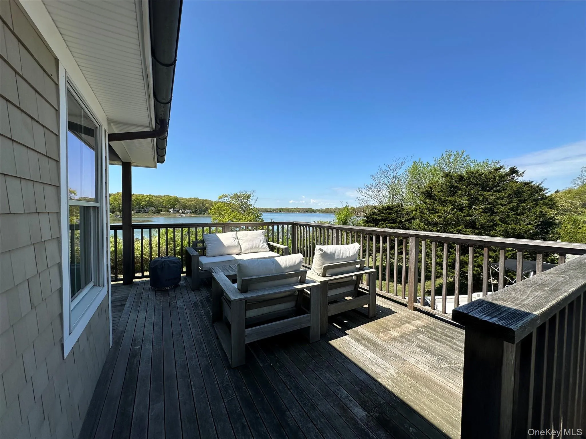 Deck featuring outdoor lounge area and a water view Deck featuring outdoor lounge area and a water view