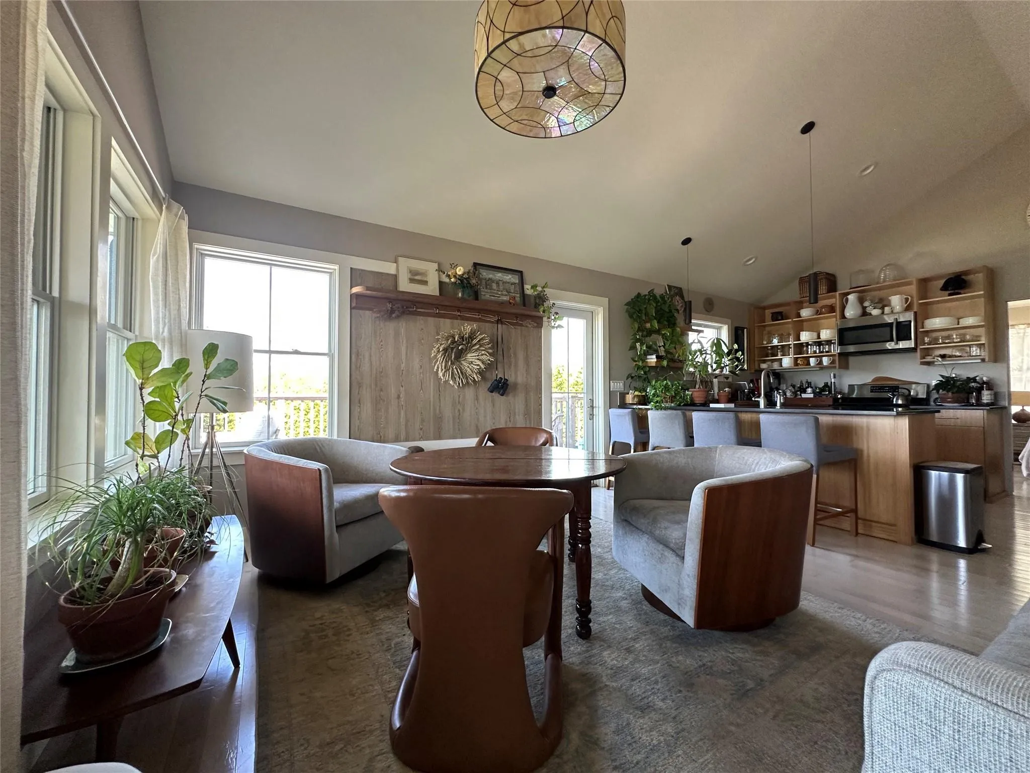 Living room with dark wood-type flooring and high vaulted ceiling Living room with dark wood-type flooring and high vaulted ceiling