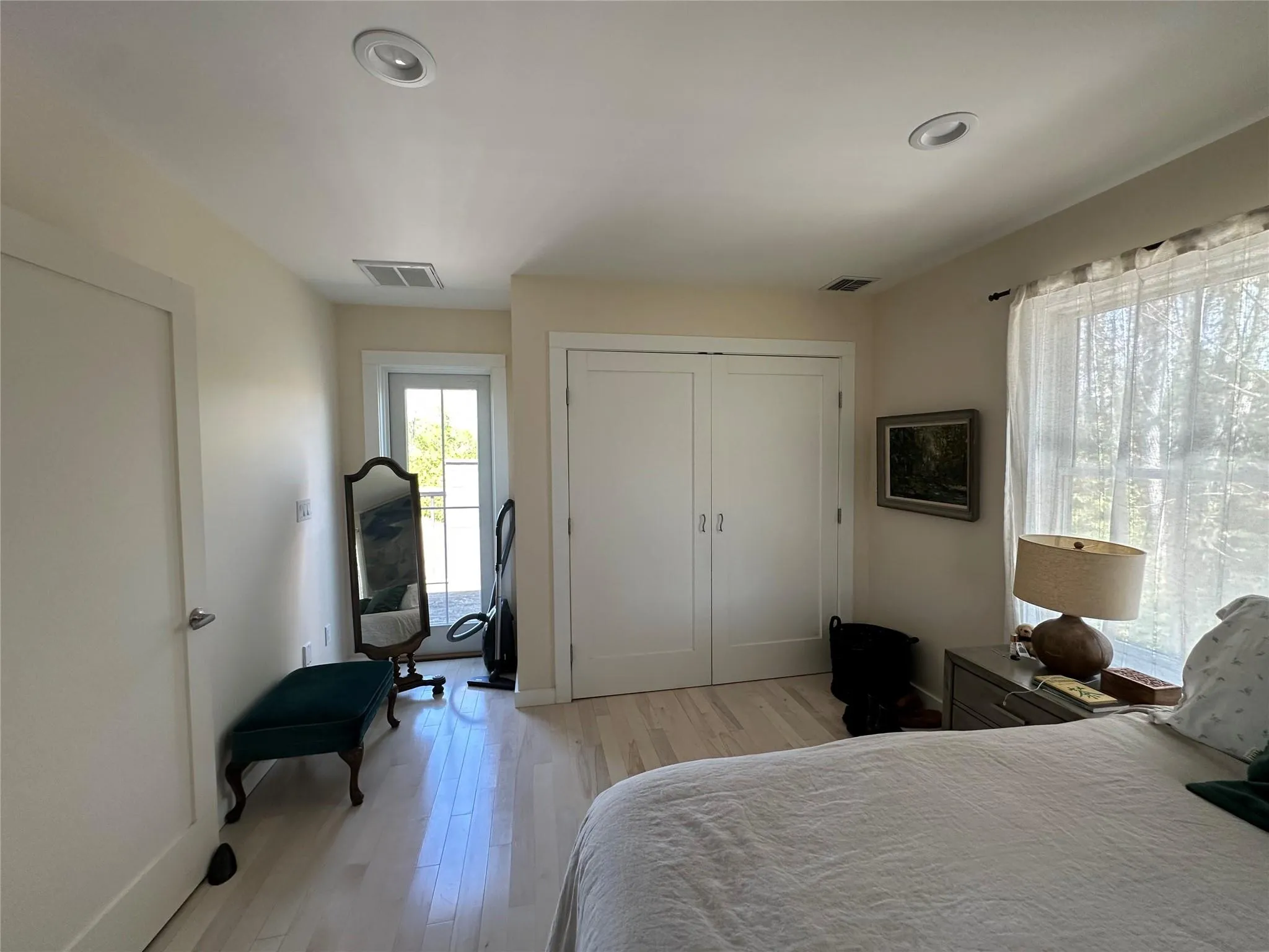 Bedroom with light wood-style flooring, a closet, and recessed lighting Bedroom with light wood-style flooring, a closet, and recessed lighting