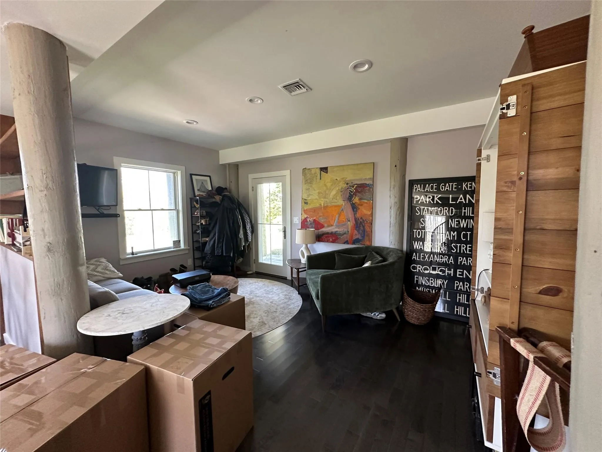 Living area with dark wood finished floors and recessed lighting Living area with dark wood finished floors and recessed lighting