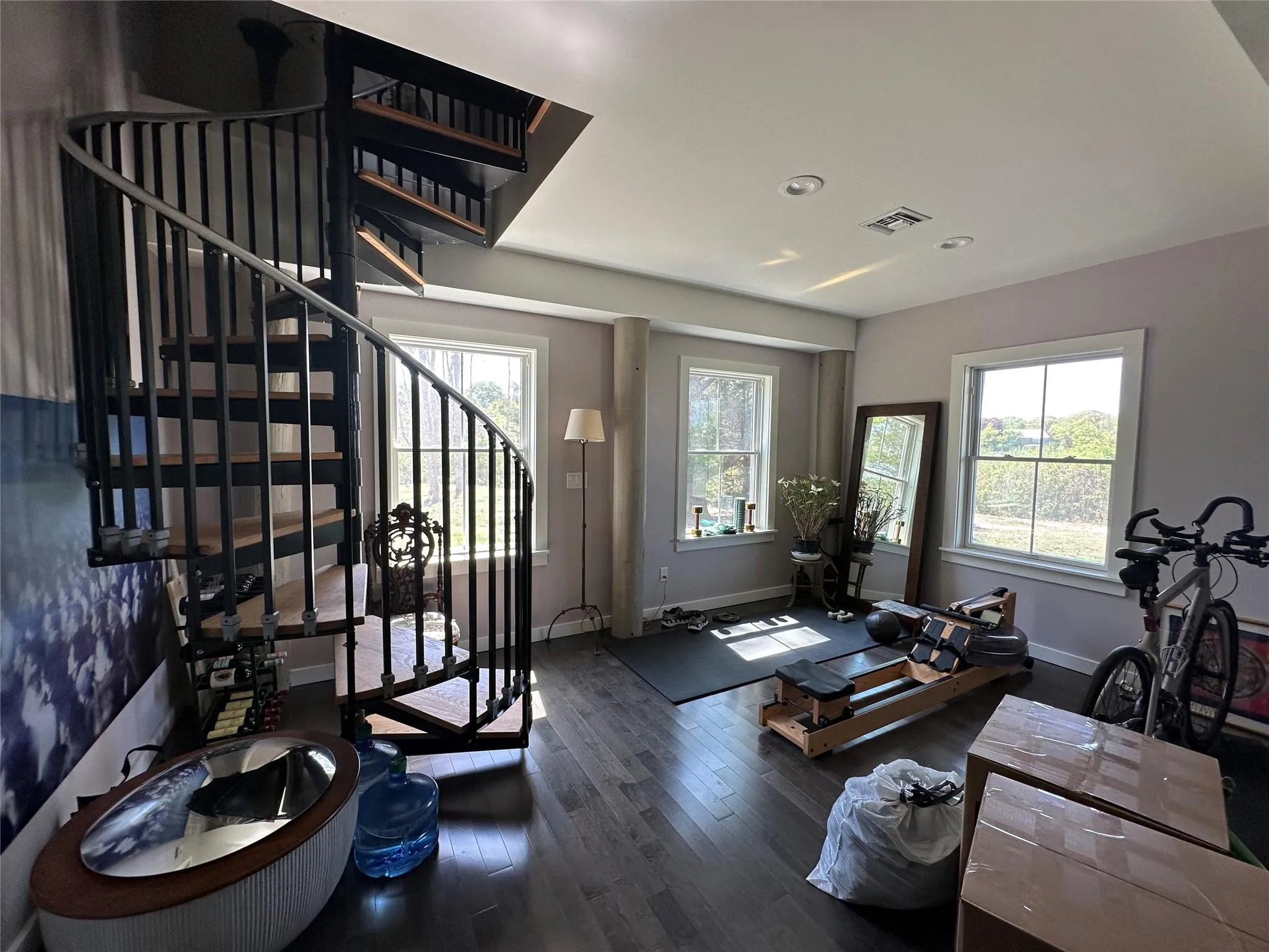 Living room with wood finished floors, stairs, and recessed lighting Living room with wood finished floors, stairs, and recessed lighting