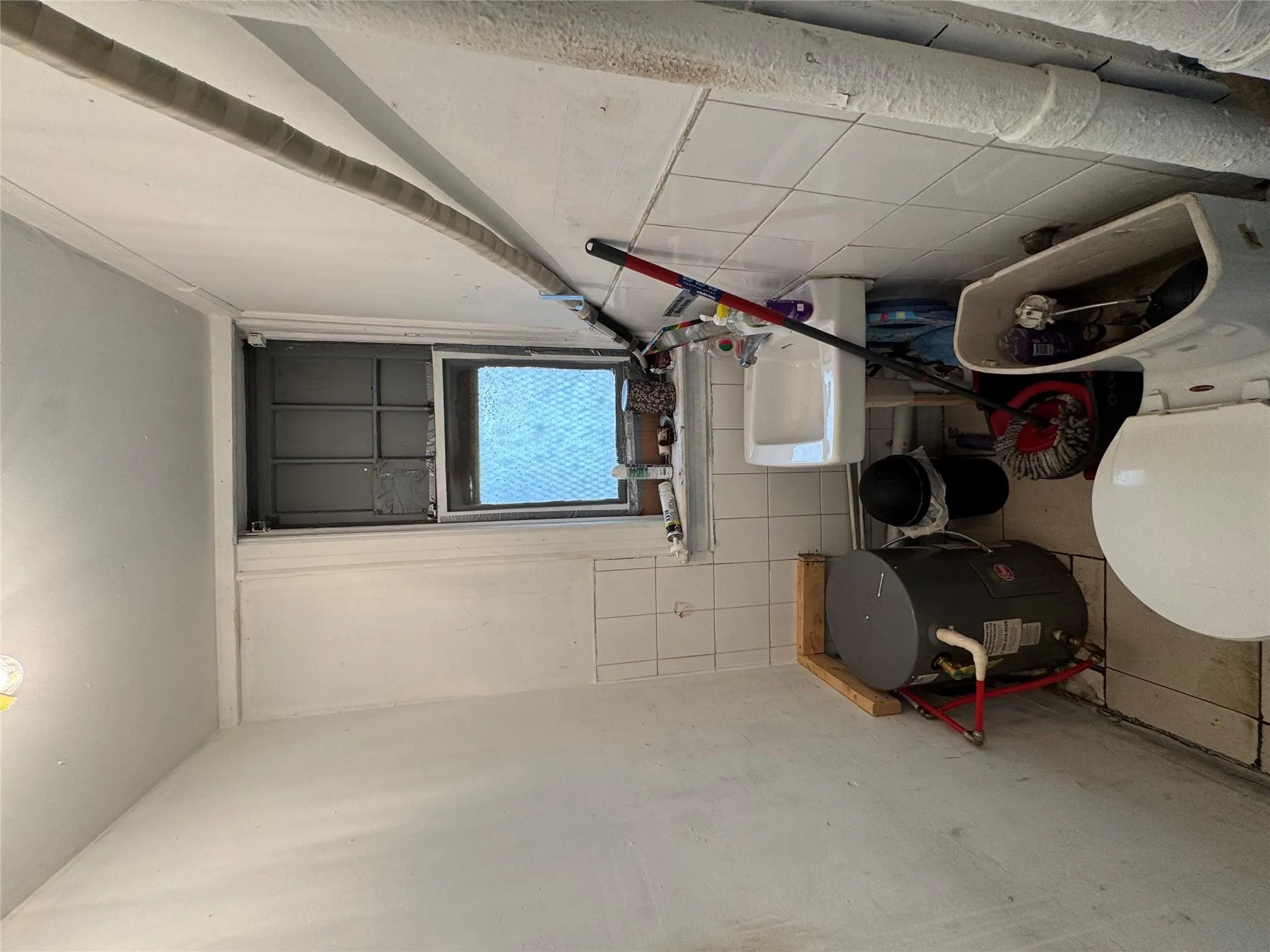 Half bath with tile walls and a wainscoted wall Half bath with tile walls and a wainscoted wall