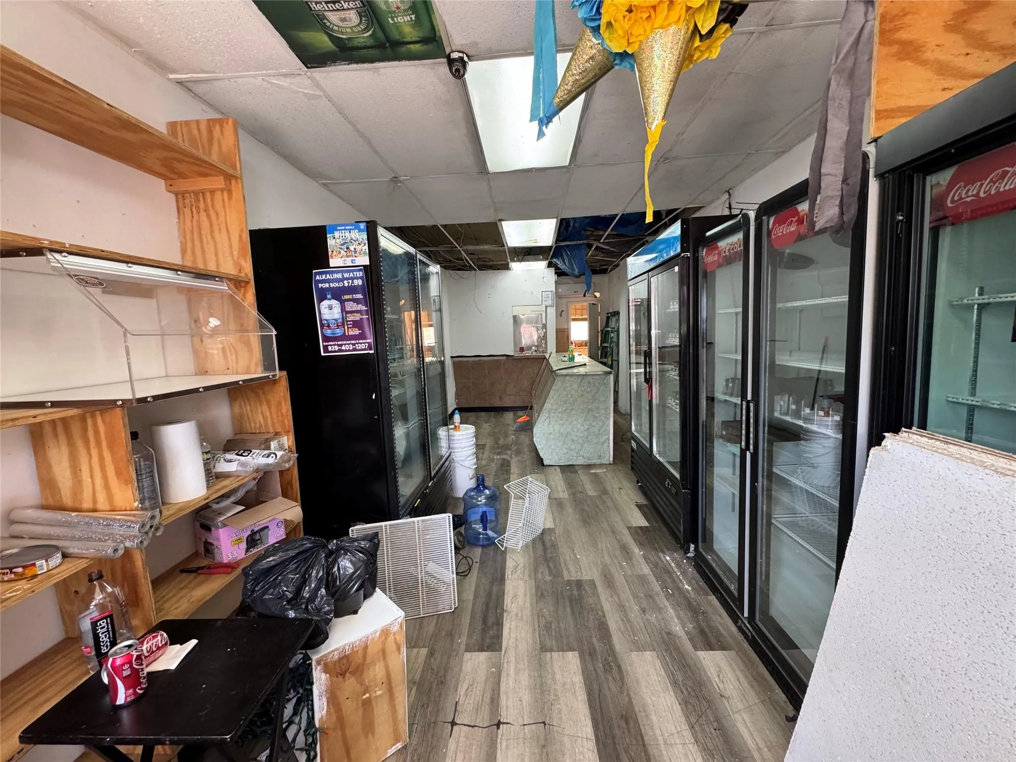Corridor featuring wood finished floors and a paneled ceiling Corridor featuring wood finished floors and a paneled ceiling