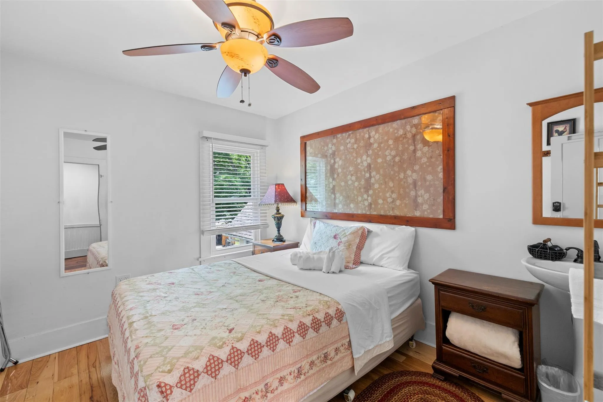 Bedroom with wood finished floors and ceiling fan Bedroom with wood finished floors and ceiling fan