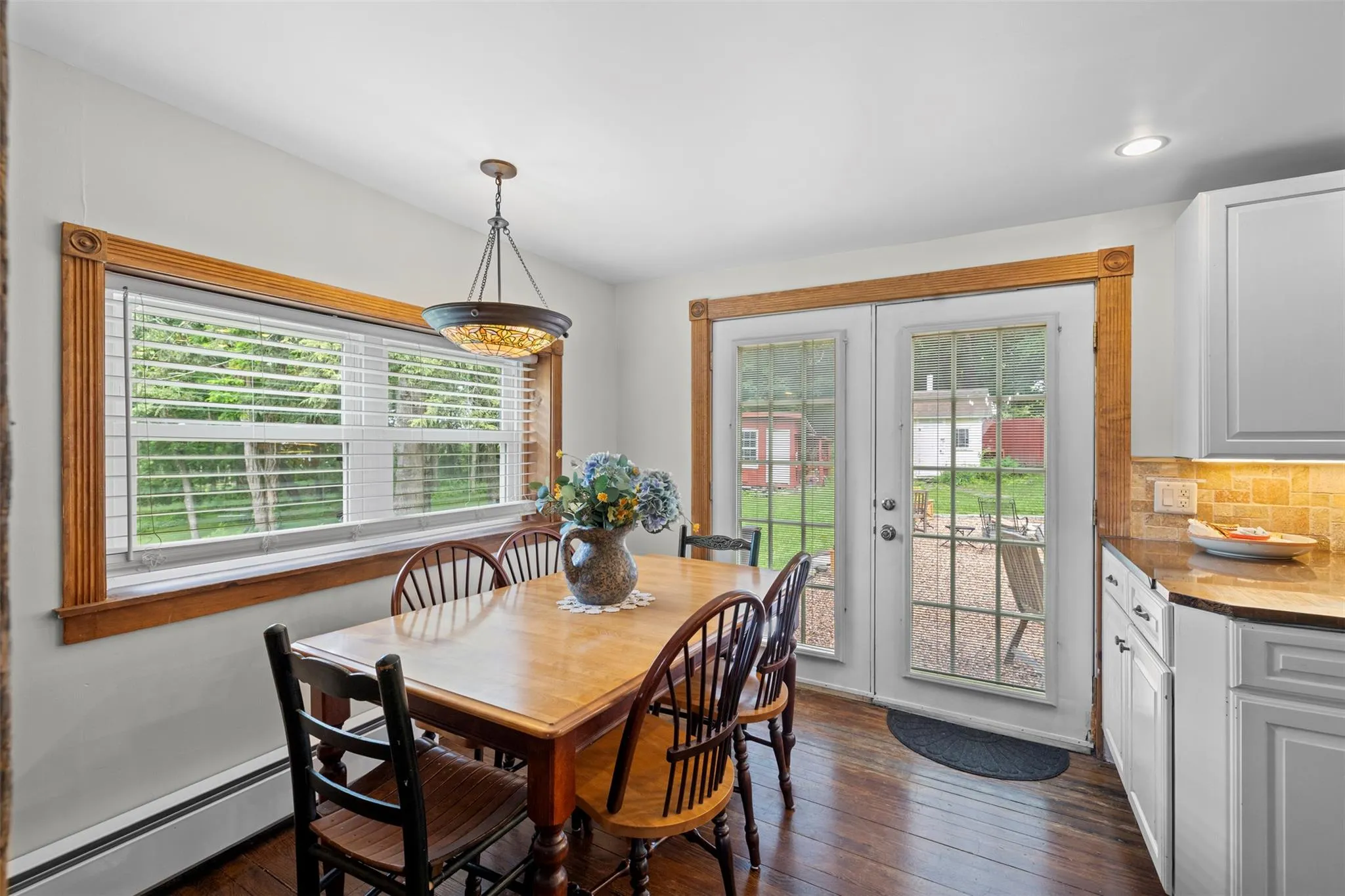 Dining area featuring a baseboard radiator, dark wood-style flooring, french doors, and recessed lighting Dining area featuring a baseboard radiator, dark wood-style flooring, french doors, and recessed lighting