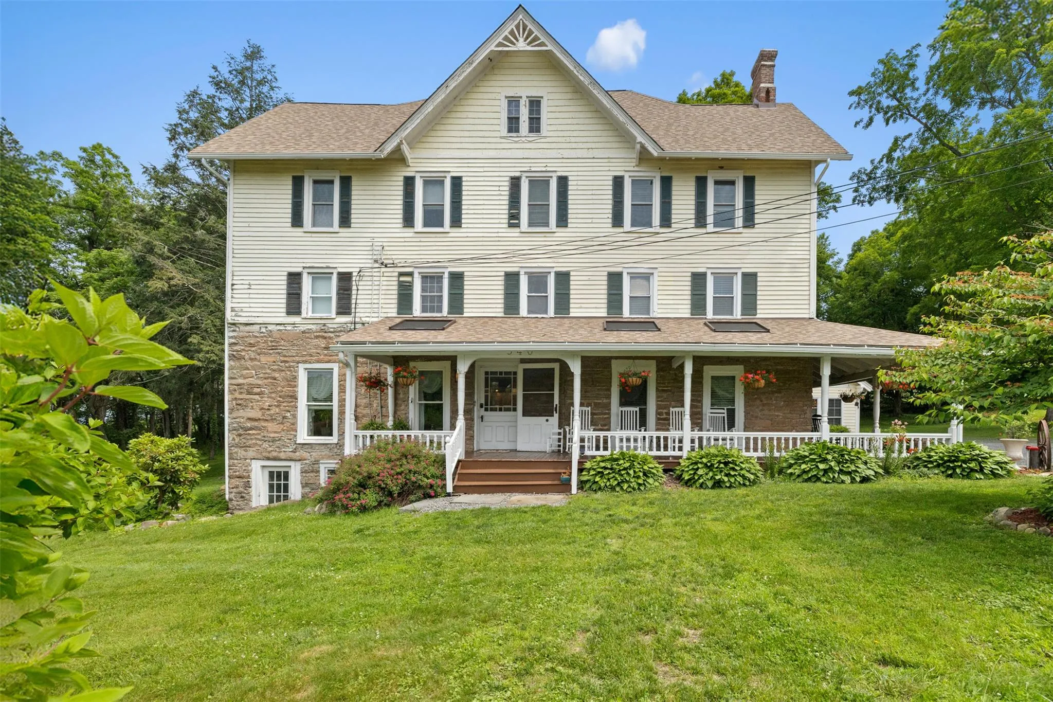 View of front of home featuring a chimney, a front yard, and a porch View of front of home featuring a chimney, a front yard, and a porch