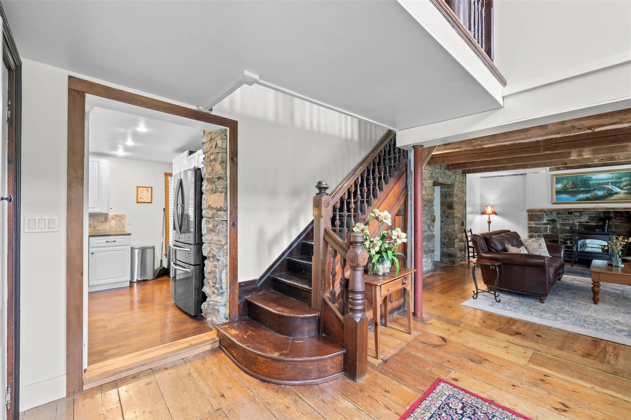 Staircase featuring hardwood / wood-style flooring Staircase featuring hardwood / wood-style flooring