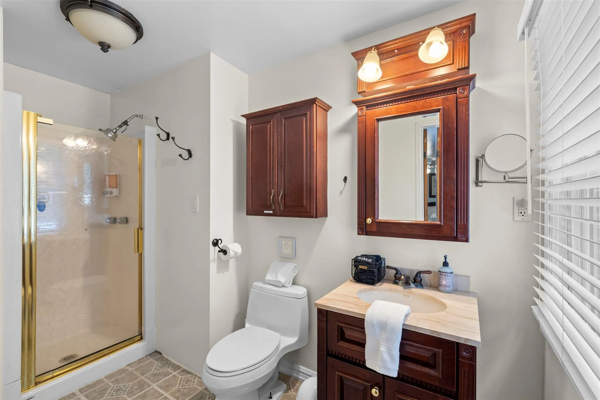 Full bath featuring a stall shower and vanity Full bath featuring a stall shower and vanity