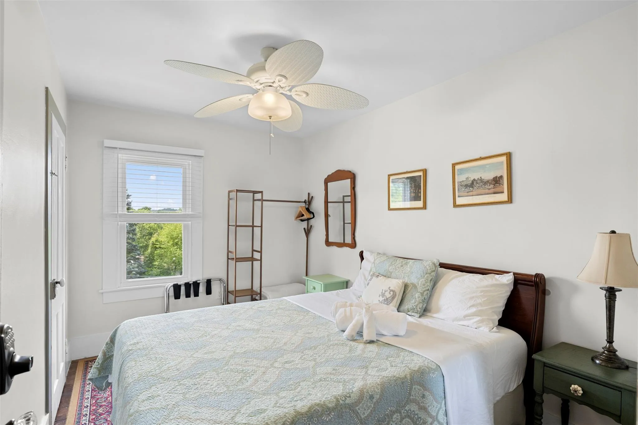 Bedroom featuring wood finished floors and ceiling fan Bedroom featuring wood finished floors and ceiling fan