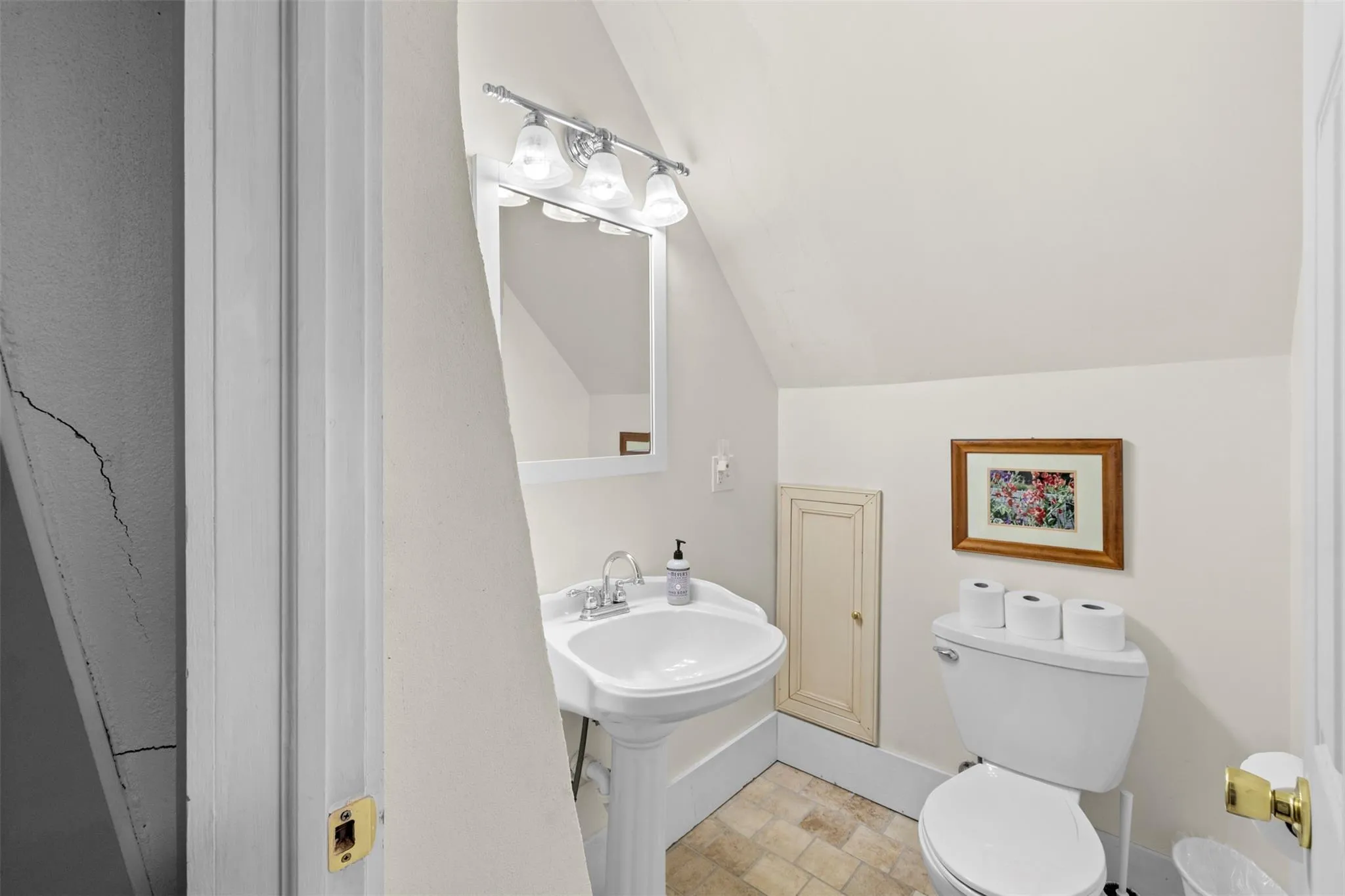 Bathroom featuring lofted ceiling and stone finish flooring Bathroom featuring lofted ceiling and stone finish flooring