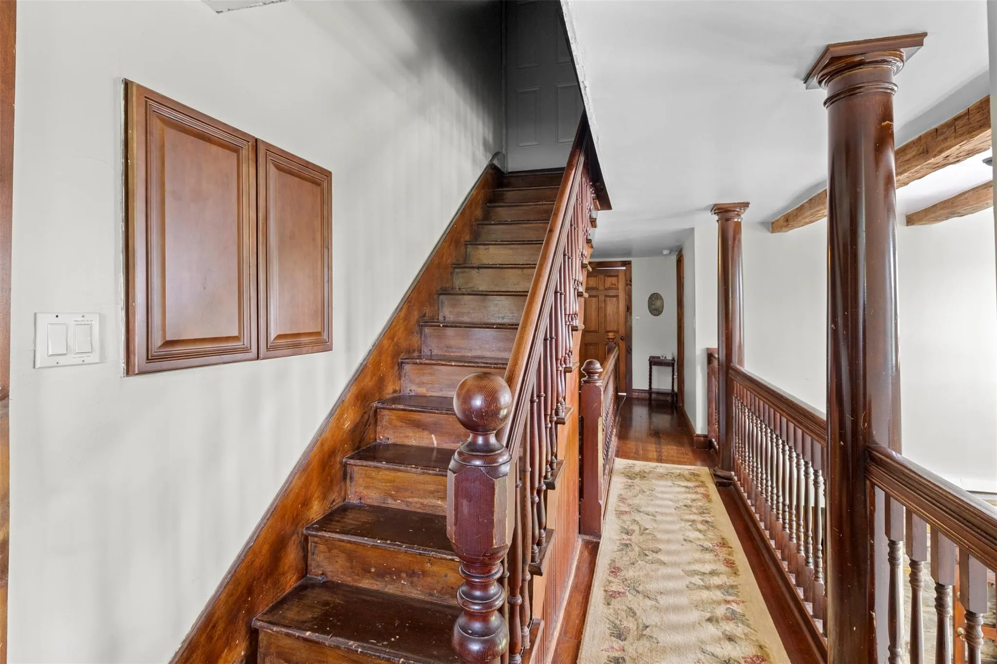 Stairway featuring decorative columns Stairway featuring decorative columns