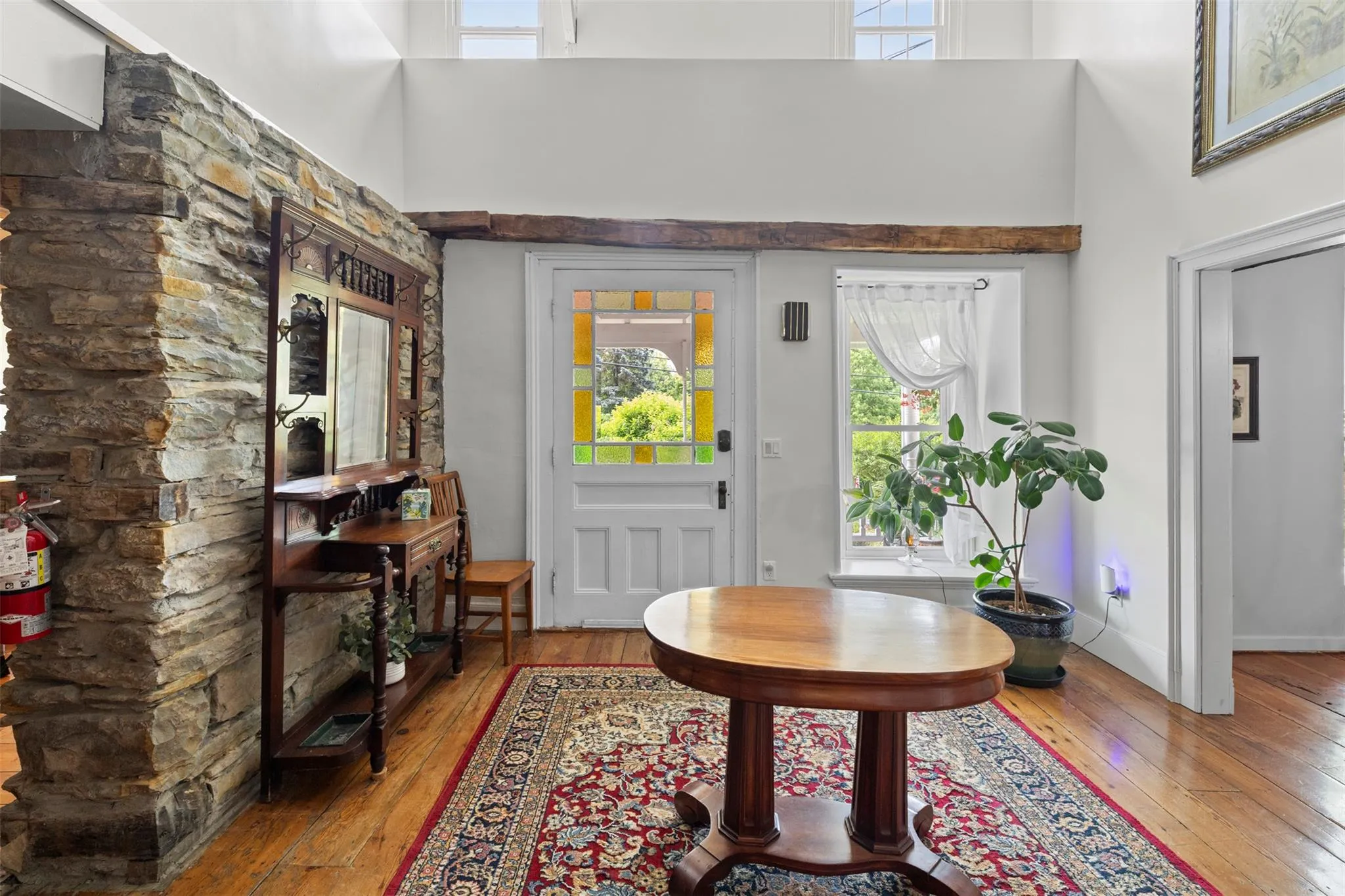 Entrance foyer featuring hardwood / wood-style flooring and a towering ceiling Entrance foyer featuring hardwood / wood-style flooring and a towering ceiling