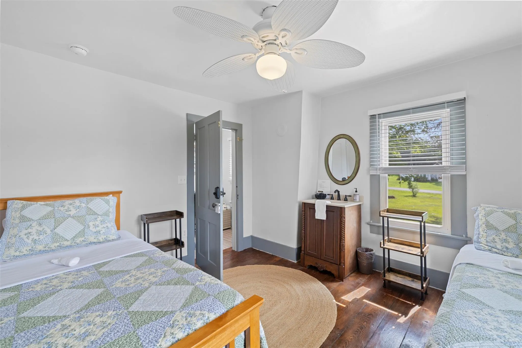 Bedroom featuring dark wood-type flooring and a ceiling fan Bedroom featuring dark wood-type flooring and a ceiling fan