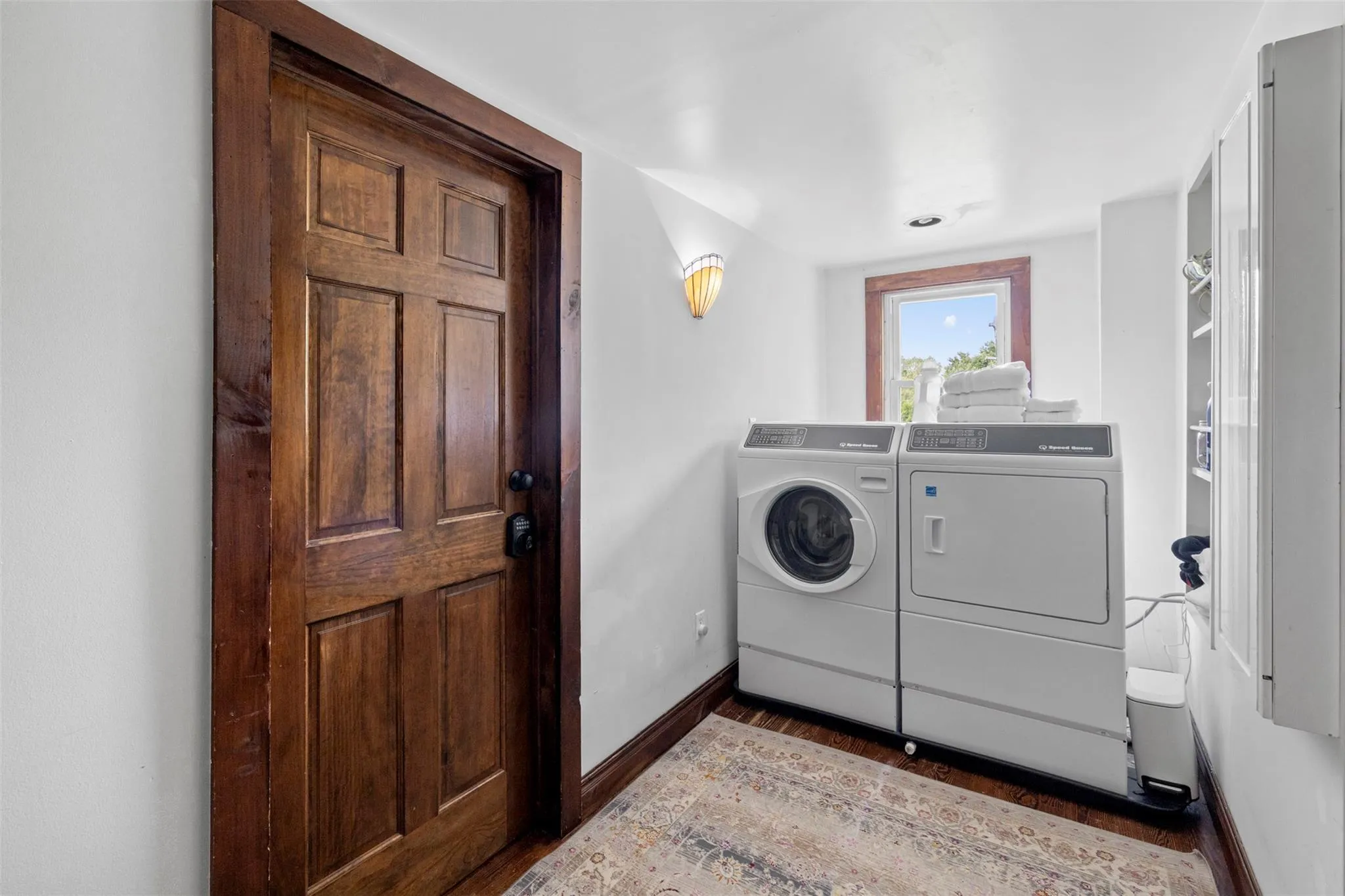 Laundry room featuring washer and clothes dryer and wood finished floors Laundry room featuring washer and clothes dryer and wood finished floors