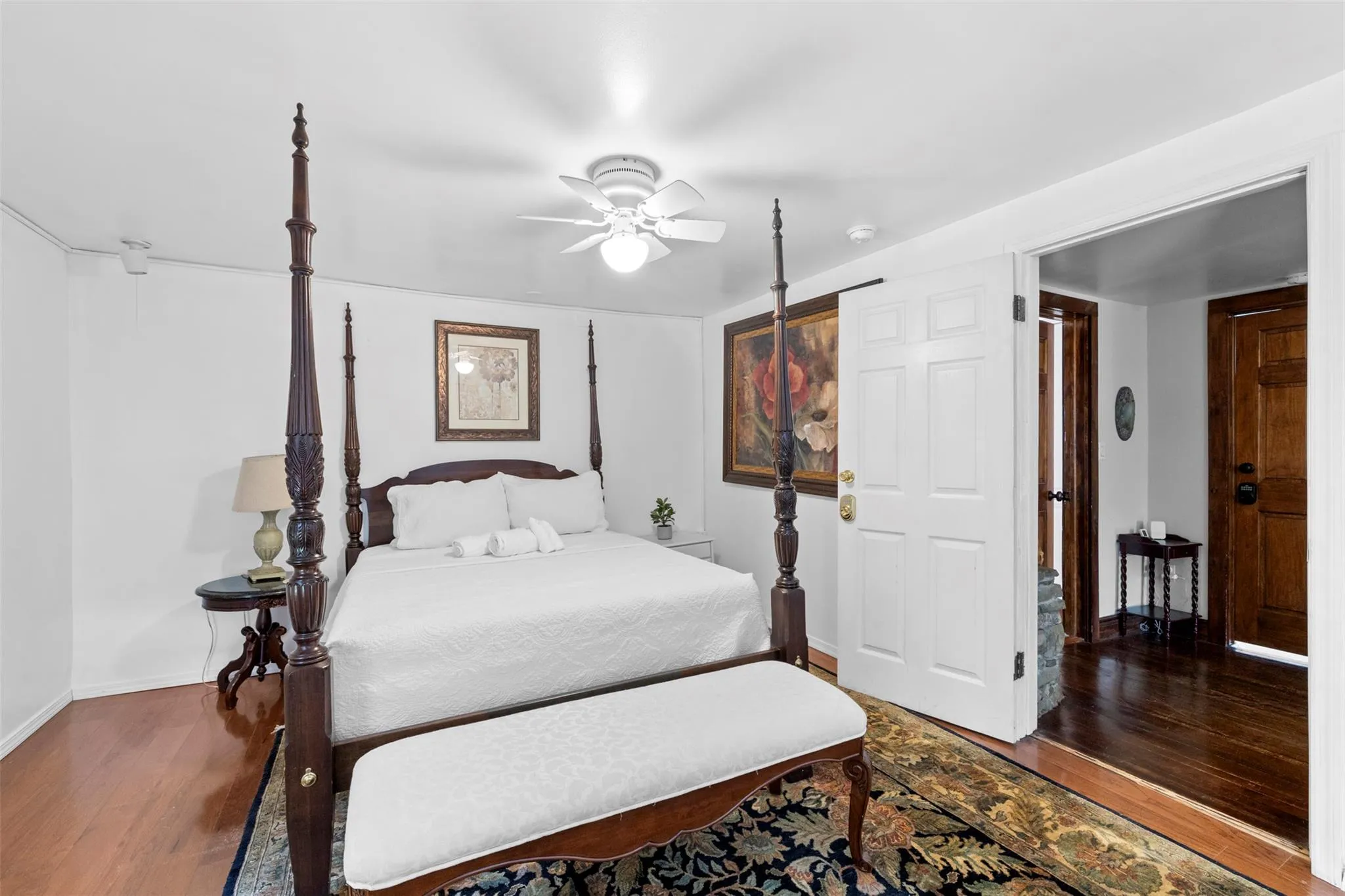 Bedroom with wood finished floors and ceiling fan Bedroom with wood finished floors and ceiling fan
