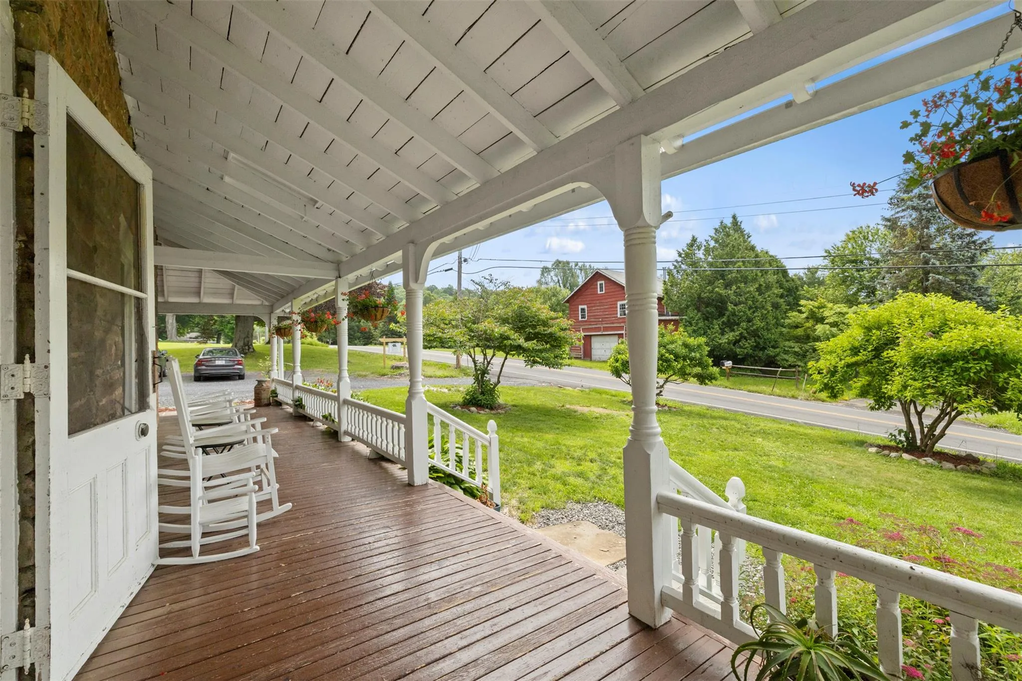 Wooden porch featuring a lawn Wooden porch featuring a lawn