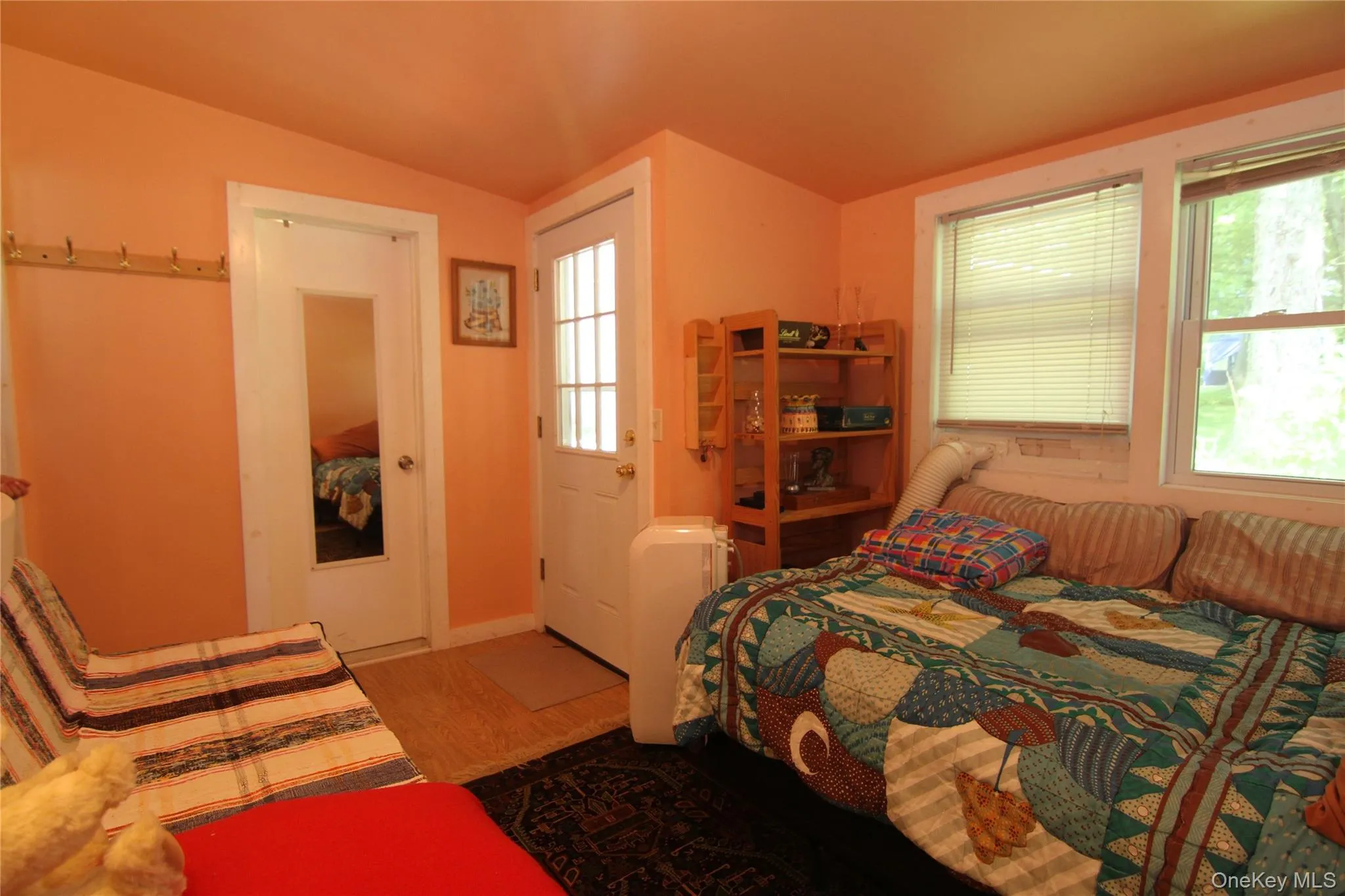 Bedroom with vaulted ceiling and wood finished floors Bedroom with vaulted ceiling and wood finished floors