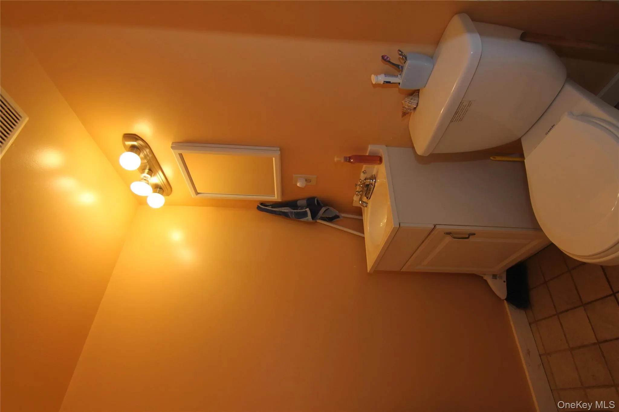Bathroom featuring vanity and tile patterned floors Bathroom featuring vanity and tile patterned floors