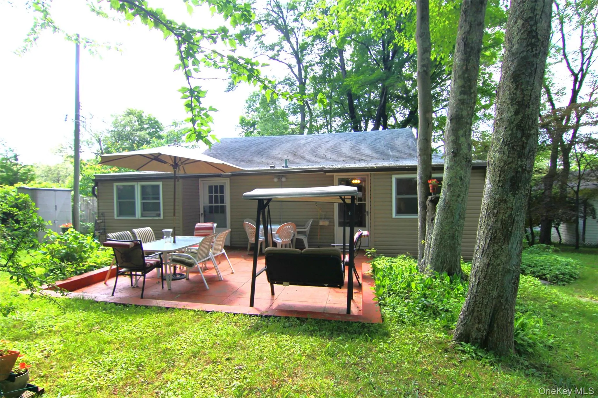 Rear view of property with a patio area and a yard Rear view of property with a patio area and a yard