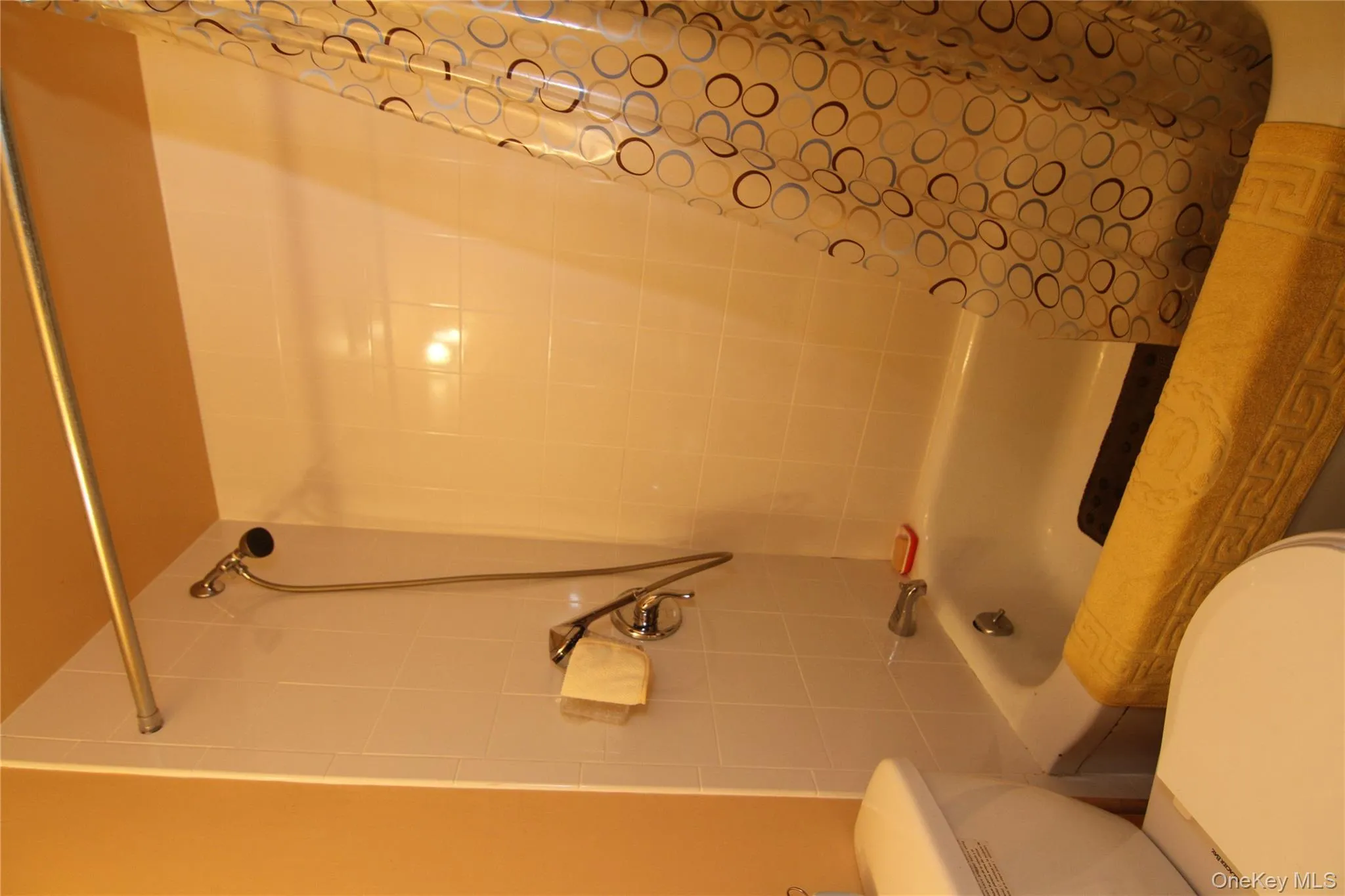 Bathroom with shower / bath combination with curtain and toilet Bathroom with shower / bath combination with curtain and toilet
