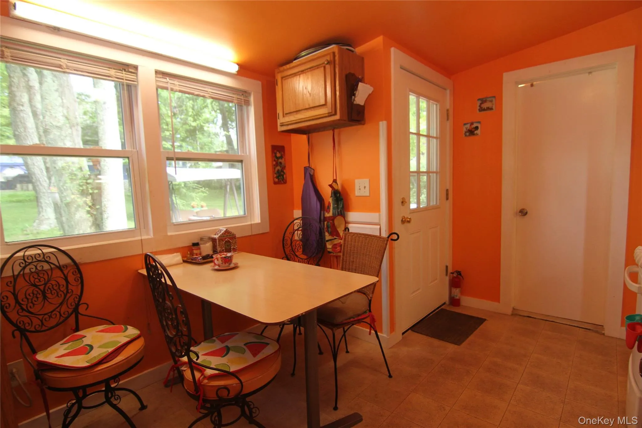Dining room featuring vaulted ceiling and light tile patterned flooring Dining room featuring vaulted ceiling and light tile patterned flooring