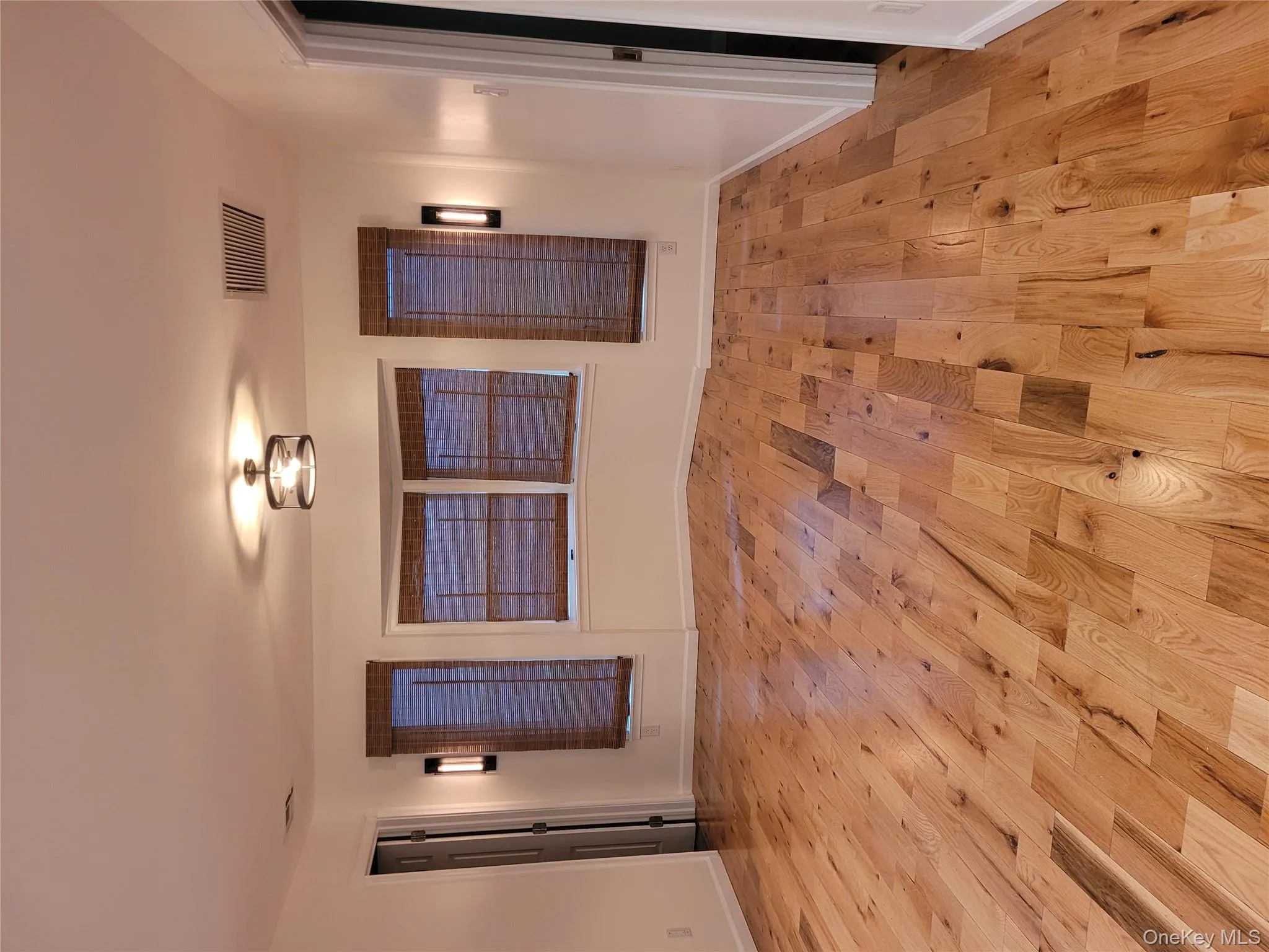 Empty room with light wood-style flooring and baseboards Empty room with light wood-style flooring and baseboards