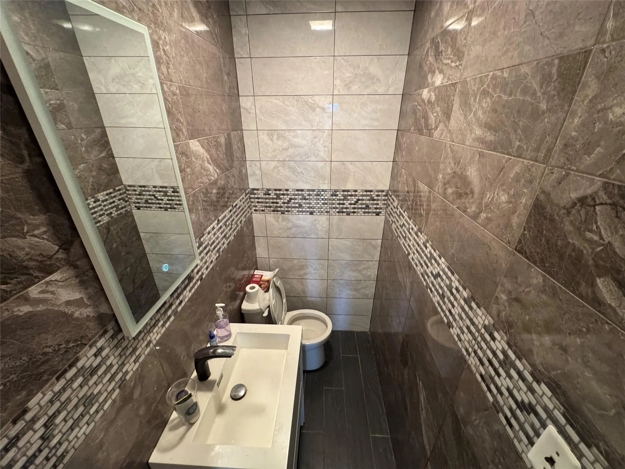 Bathroom with toilet and tile walls Bathroom with toilet and tile walls