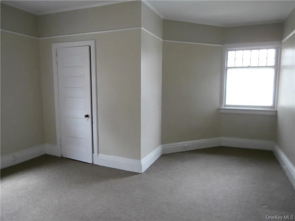 Unfurnished room featuring carpet flooring and baseboards Unfurnished room featuring carpet flooring and baseboards