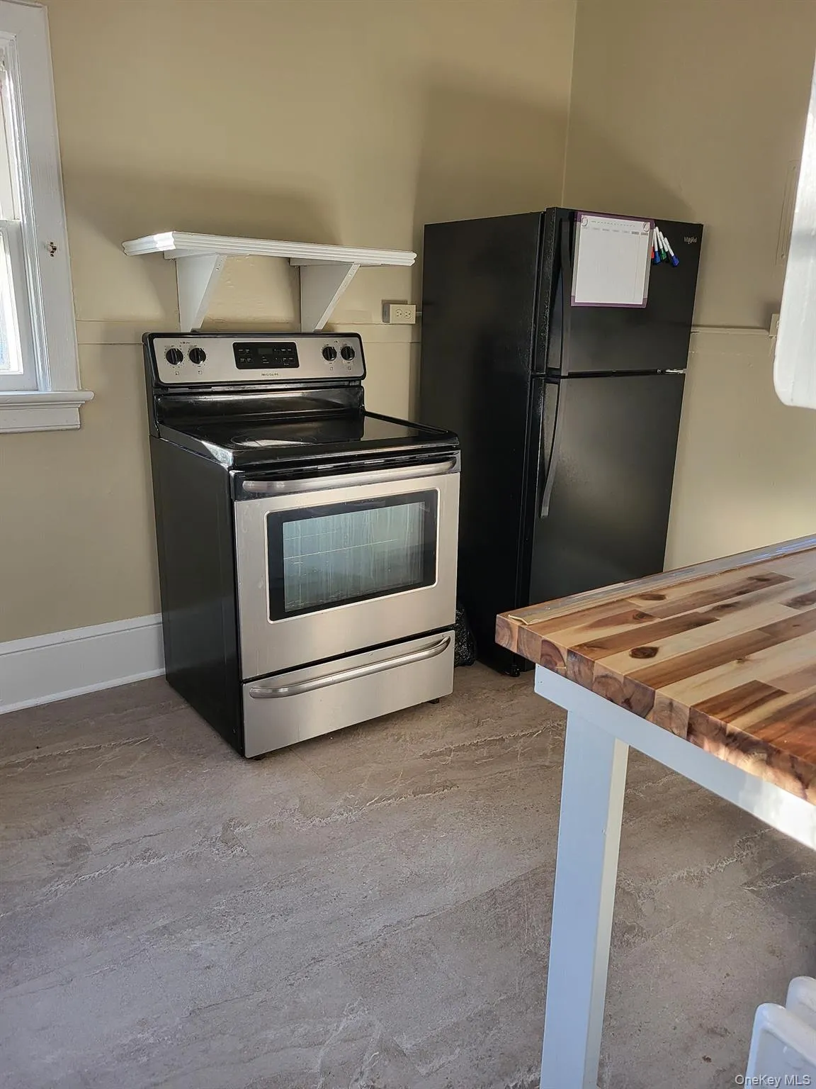 Electric range oven and freestanding refrigerator. Electric range oven and freestanding refrigerator.