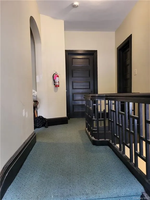 Corridor with carpet flooring and arched walkways Corridor with carpet flooring and arched walkways
