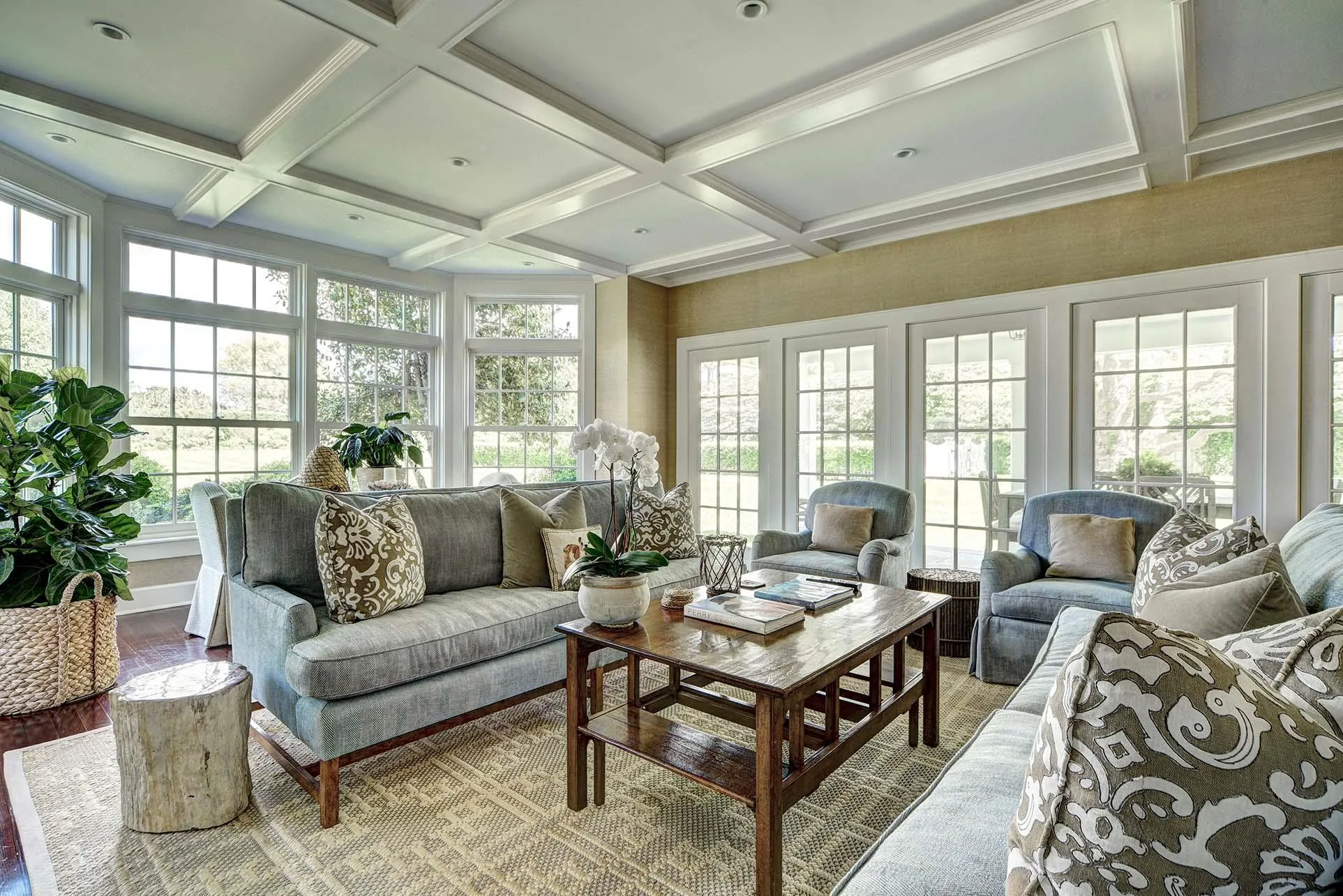 Sunroom / solarium featuring french doors, coffered ceiling, wood finished floors, and beam ceiling Sunroom / solarium featuring french doors, coffered ceiling, wood finished floors, and beam ceiling